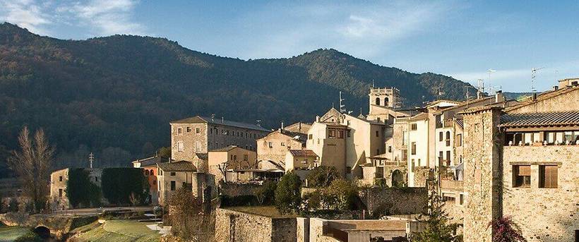 The rooftops over Besalu with mountains in the distance 
