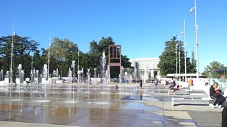 War memorial chair with broken leg and fountains in Geneva