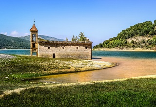 The ruins of St Nicholas Church on the shore of Lake Mavorovo