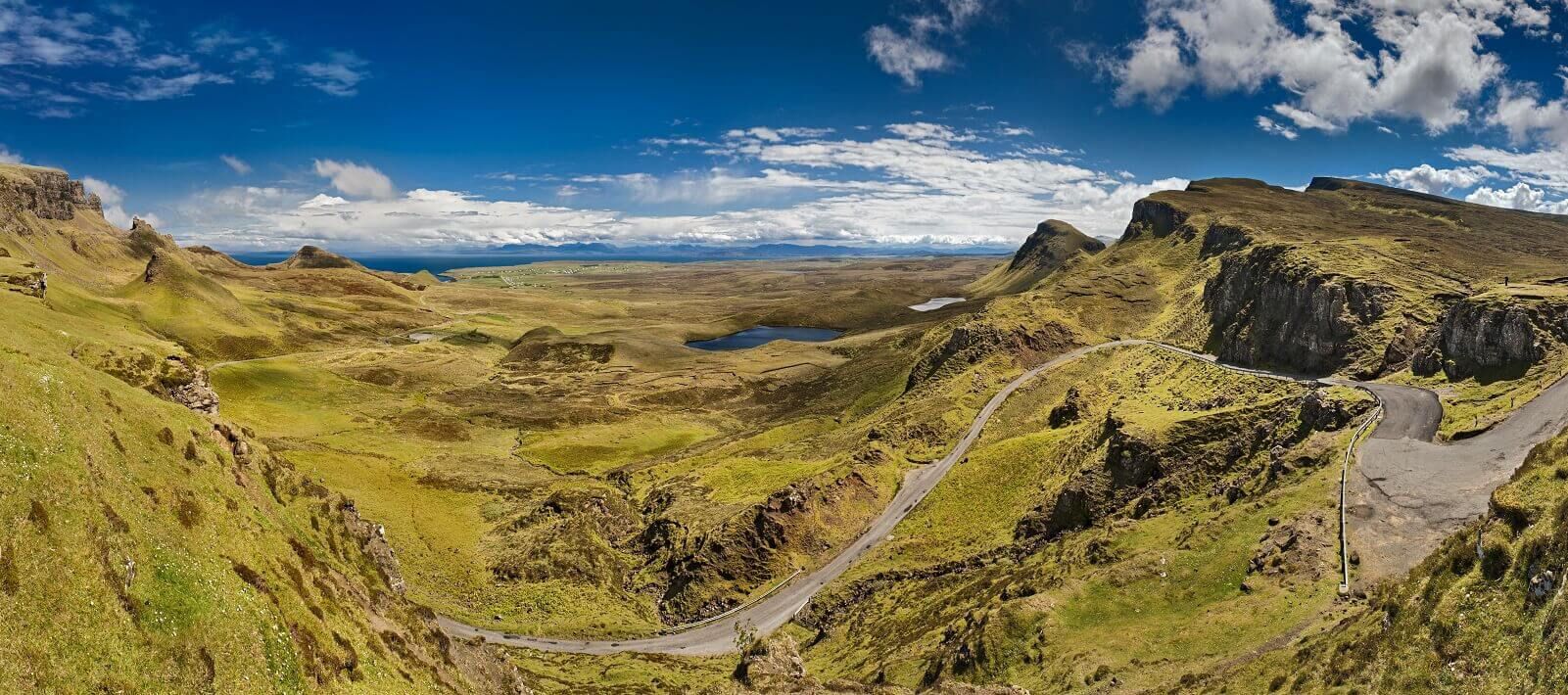 the Quiraing on the Isle of Skye showing the road winding up the hill with a view to the south and the sea beyond - scottish motorcycle tour