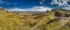 the Quiraing on the Isle of Skye showing the road winding up the hill with a view to the south and the sea beyond - scottish motorcycle tour