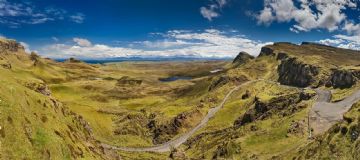 the Quiraing on the Isle of Skye showing the road winding up the hill with a view to the south and the sea beyond - scottish motorcycle tour