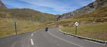 Rider approaching with mountains behind taken near Formingal, in the Spanish Pyrenees